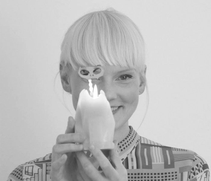 balck and white picture of 54 celsius owner, Thorunn, holding kisa the cat candle. 